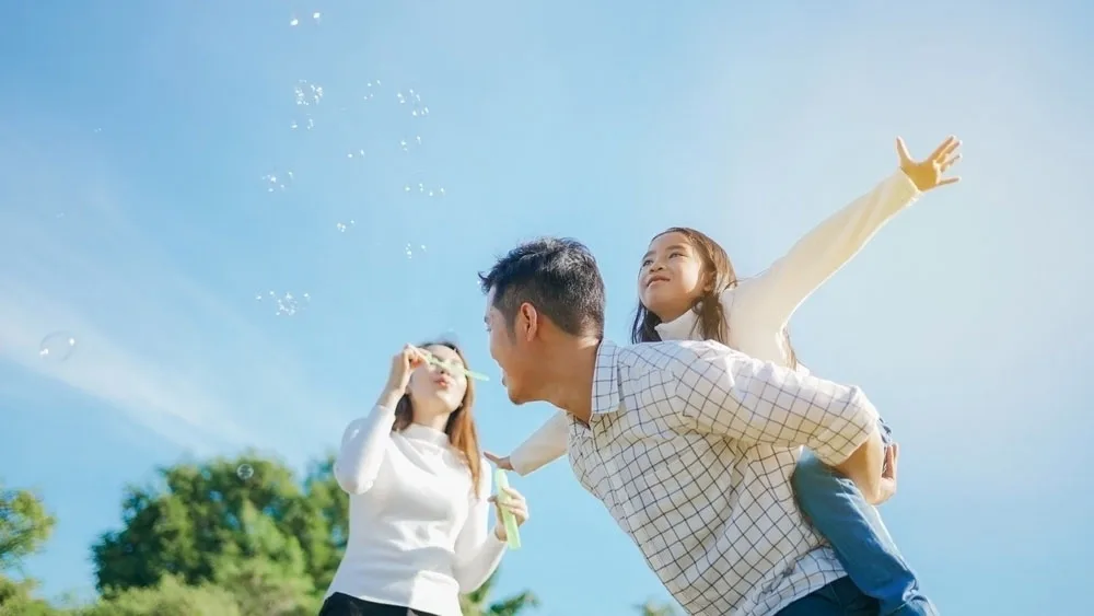 A family smiling together outdoors