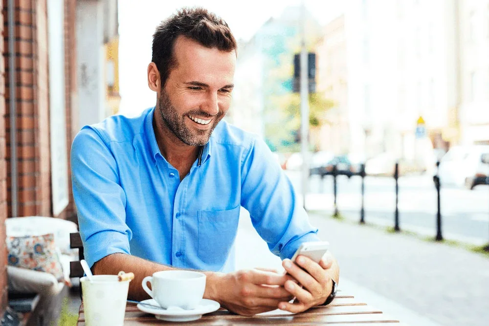 Dental Crowns Woodstock Man smiling in a plain portrait